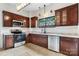 Kitchen featuring dark wood cabinetry, stainless steel appliances, tile flooring and plenty of natural light at 425 1St Se Ave, Hickory, NC 28602