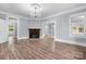 Spacious living room featuring hardwood floors, a brick fireplace, and an elegant chandelier at 425 1St Se Ave, Hickory, NC 28602