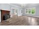 Bright and airy living room featuring hardwood floors, a brick fireplace, and large windows at 425 1St Se Ave, Hickory, NC 28602