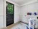 Storage room with white walls, a dark door to the outside and cans of paint at 425 1St Se Ave, Hickory, NC 28602