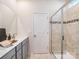 Clean bathroom featuring a glass-enclosed shower, vanity with modern fixtures, and neutral tile at 4400 Dusty Orchard Rd, Kannapolis, NC 28081