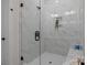 Modern bathroom shower with black hardware and marble-style tile at 4419 Splash Trl # 158, Sherrills Ford, NC 28673