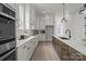 An open kitchen featuring stainless steel appliances, light wood floors and sleek white cabinetry at 4419 Splash Trl # 158, Sherrills Ford, NC 28673