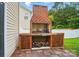 Custom brick fireplace with firewood storage in backyard sitting area at 512 Nanny Point Dr, Monroe, NC 28110