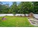 Spacious backyard with a swing, shed, and white fence offering a private outdoor oasis at 512 Nanny Point Dr, Monroe, NC 28110