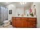 Well-lit bathroom with double vanity, neutral tile, and a framed mirror at 512 Nanny Point Dr, Monroe, NC 28110