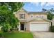 Charming two-story home with a two-car garage and well-maintained lawn at 512 Nanny Point Dr, Monroe, NC 28110