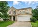 Charming two-story home with a two-car garage and well-maintained lawn at 512 Nanny Point Dr, Monroe, NC 28110