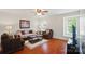 Cozy living room with hardwood floors, a ceiling fan, and plenty of natural light at 512 Nanny Point Dr, Monroe, NC 28110