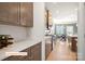 Elegant kitchen with light countertops, stainless appliances, and an open view to the dining area at 518 Hullview Vista Vis # 15, Monroe, NC 28110