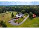 Aerial view shows a beautiful home with a long driveway and lots of trees in a country setting at 5258 E Bandys Cross Rd, Catawba, NC 28609