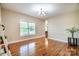 Bright dining room featuring hardwood floors, a large window, and elegant chandelier lighting at 5258 E Bandys Cross Rd, Catawba, NC 28609