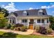 Charming home boasts a welcoming front porch, beautiful landscaping, and a stone and vinyl facade at 5258 E Bandys Cross Rd, Catawba, NC 28609