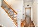 Hallway featuring wood floors and a staircase with wood and black metal railings leading to the second floor at 5258 E Bandys Cross Rd, Catawba, NC 28609