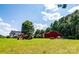 Large piece of land with barn, farm equipment, and beautiful treeline in the background at 5258 E Bandys Cross Rd, Catawba, NC 28609