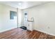 Bright laundry room with a utility sink, white cabinetry, and durable laminate floors at 5258 E Bandys Cross Rd, Catawba, NC 28609