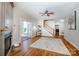 Open living room with fireplace, staircase, hardwood floors, and access to a sunroom at 5258 E Bandys Cross Rd, Catawba, NC 28609
