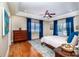 Tranquil main bedroom with tray ceiling, wood floors, a ceiling fan, and large bright windows at 5258 E Bandys Cross Rd, Catawba, NC 28609