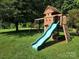 Outdoor playground with a slide, swings, and climbing features set in a grassy yard at 5258 E Bandys Cross Rd, Catawba, NC 28609