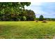 Large grassy yard with mature trees, fire pit, and trampoline in a peaceful setting in a home for sale at 5258 E Bandys Cross Rd, Catawba, NC 28609