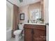 Well-appointed bathroom with patterned wallpaper, a modern vanity, and a shower-tub combination at 5508 Swaling St, Charlotte, NC 28217