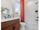Modern bathroom with a dark-wood vanity, white subway tile, and a view from the bright window at 5508 Swaling St, Charlotte, NC 28217