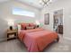Cozy bedroom features a large window, stylish lighting, and a view into the adjoining bathroom at 5508 Swaling St, Charlotte, NC 28217