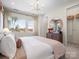 Comfortable bedroom featuring a stylish chandelier, a plush bed, and an en-suite bathroom at 5508 Swaling St, Charlotte, NC 28217