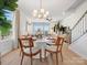 Stylish dining room featuring a contemporary chandelier, neutral tones, and seamless flow into the living area at 5508 Swaling St, Charlotte, NC 28217