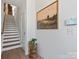 Bright foyer featuring hardwood floors and stairs, a stylish table with plant, and a landscape art piece at 5508 Swaling St, Charlotte, NC 28217
