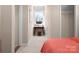 Well-lit hallway with a desk, stool, closet, neutral walls, and bright views from the window at 5508 Swaling St, Charlotte, NC 28217