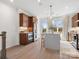 Modern kitchen with stainless steel appliances, a center island with seating, and wood cabinetry at 5508 Swaling St, Charlotte, NC 28217