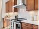 New kitchen boasts stainless steel appliances, designer finishes, and white quartz countertops and backsplash at 5508 Swaling St, Charlotte, NC 28217