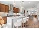 An open kitchen features a central island, stainless steel appliances, and stylish pendant lighting at 5508 Swaling St, Charlotte, NC 28217