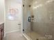 Modern bathroom featuring a glass-enclosed shower with sleek fixtures and neutral, stylish finishes at 5508 Swaling St, Charlotte, NC 28217