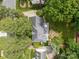 Aerial view of a home highlighting the patio, fire pit, lush backyard, and well-maintained landscaping at 5517 Alexa Rd, Charlotte, NC 28277