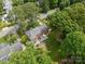 Beautiful aerial view showcasing a home's backyard with patio, fire pit, and surrounding lush greenery at 5517 Alexa Rd, Charlotte, NC 28277