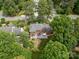 Aerial view of a beautiful home, patio, fire pit, and well-manicured backyard with lush greenery at 5517 Alexa Rd, Charlotte, NC 28277