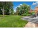 Large backyard with a deck, a table and chairs, and lush green grass and landscaping at 5517 Alexa Rd, Charlotte, NC 28277