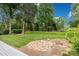 Expansive backyard with lush lawn, mature trees, stone accents, and a glimpse of the deck at 5517 Alexa Rd, Charlotte, NC 28277