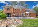 Backyard with a spacious deck, brick exterior, manicured lawn, and stone accents at 5517 Alexa Rd, Charlotte, NC 28277