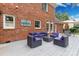Backyard deck featuring comfortable outdoor seating, a brick exterior, and well-maintained landscaping at 5517 Alexa Rd, Charlotte, NC 28277