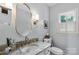 Stylish powder room with a granite countertop, gold accents, and a decorative mirror at 5517 Alexa Rd, Charlotte, NC 28277