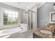Bathroom features a garden tub, glass enclosed shower, and granite countertop sink vanity at 5517 Alexa Rd, Charlotte, NC 28277