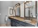 Bathroom featuring granite counters, double sinks, wooden framed mirrors, shiplap walls and a shower at 5517 Alexa Rd, Charlotte, NC 28277