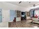 Bedroom featuring vaulted ceiling, wood floors, bookcase, and striped accent wall at 5517 Alexa Rd, Charlotte, NC 28277
