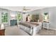 Bright bedroom featuring a ceiling fan, ensuite bathroom, and scenic views from large windows at 5517 Alexa Rd, Charlotte, NC 28277