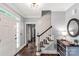 Bright and open foyer with hardwood floors, staircase, and white trim, creating a welcoming entry to the home at 5517 Alexa Rd, Charlotte, NC 28277