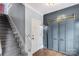 Inviting home hallway features hardwood floors, staircase, and coat closet with sliding barn doors at 5517 Alexa Rd, Charlotte, NC 28277