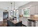 Bright kitchen with granite countertops, stainless steel appliances, and large windows overlooking yard at 5517 Alexa Rd, Charlotte, NC 28277